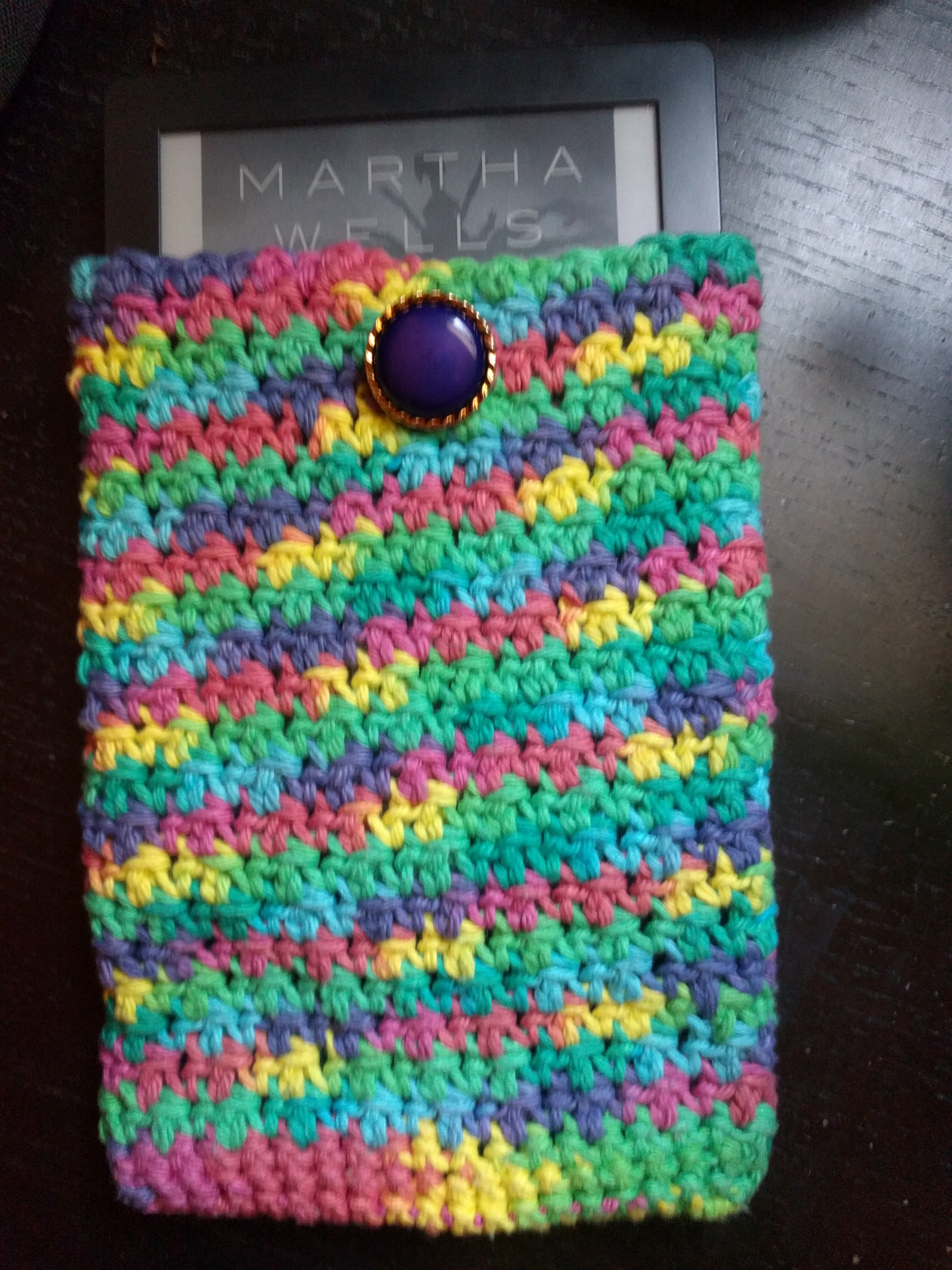 A multicolor sleeve showing an e-reader sticking out of the top