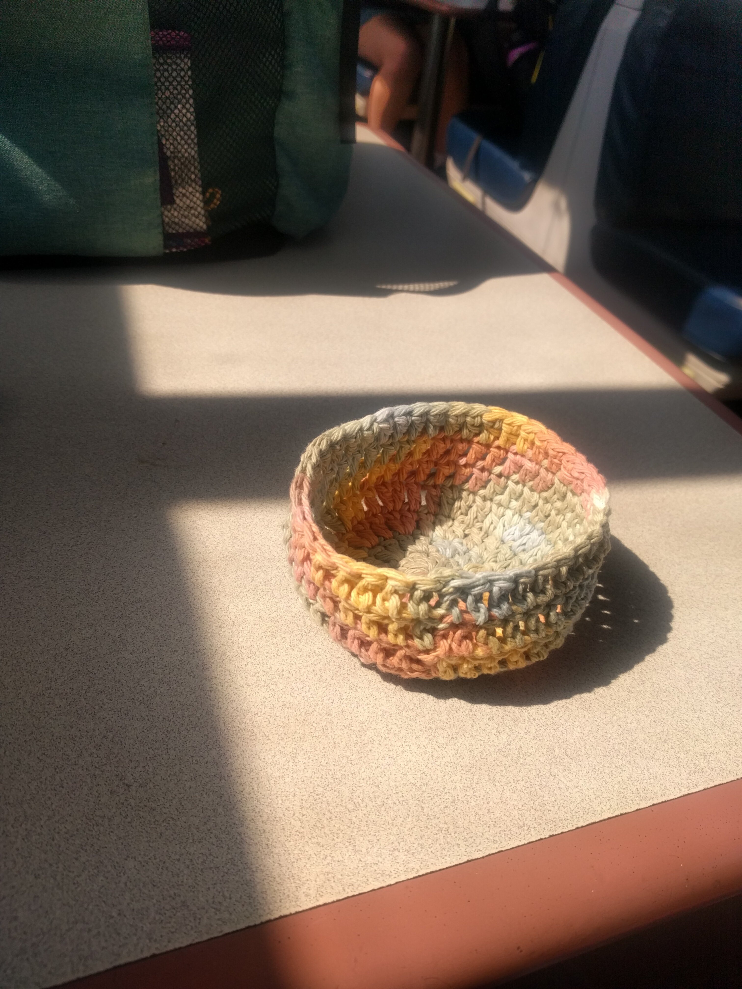 A multicolor crochet basket around 4 or 5 inches in diameter